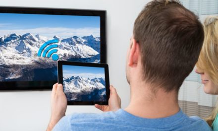 Cord cutters man and woman holding a tablet in front of a TV