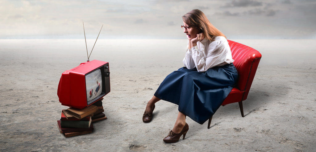 Woman watching old tv outside