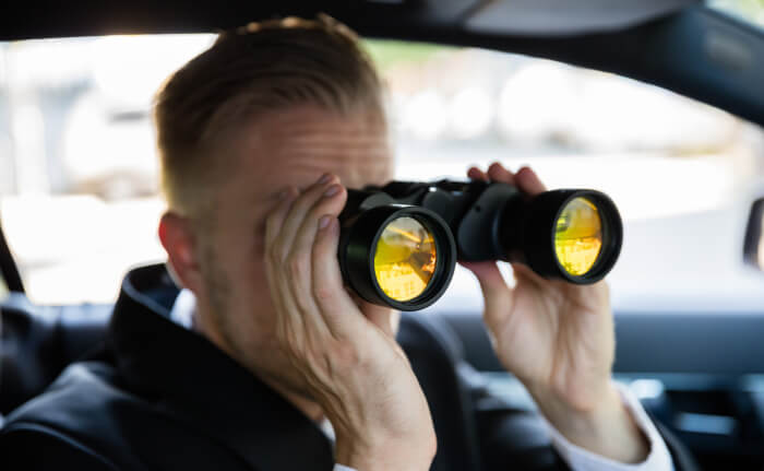 Detective looking through binoculars700