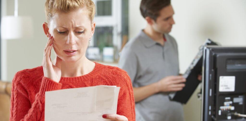 Woman looking at TV license fee bill