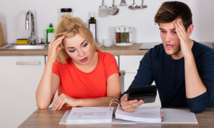 A couple with bills and a calculator