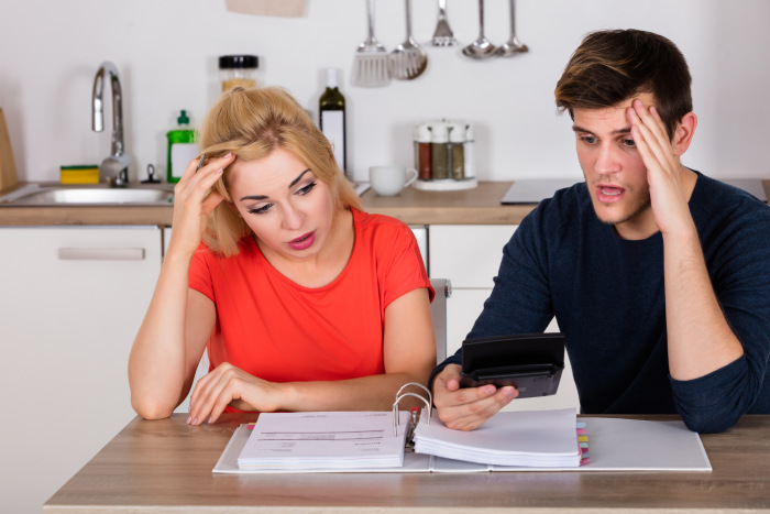 A couple with bills and a calculator