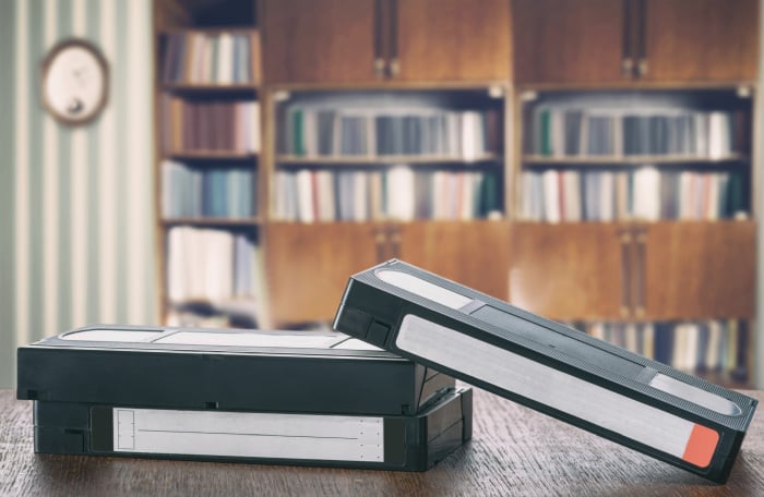 VHS tapes on wooden shelf