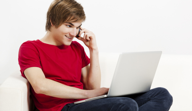 Young Man with a computer and phone