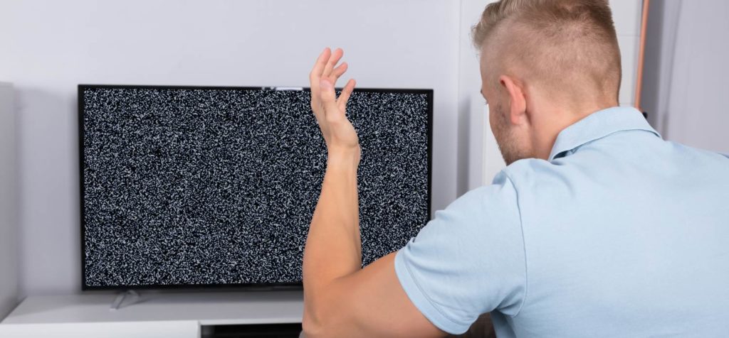 Man in front of TV with no signal