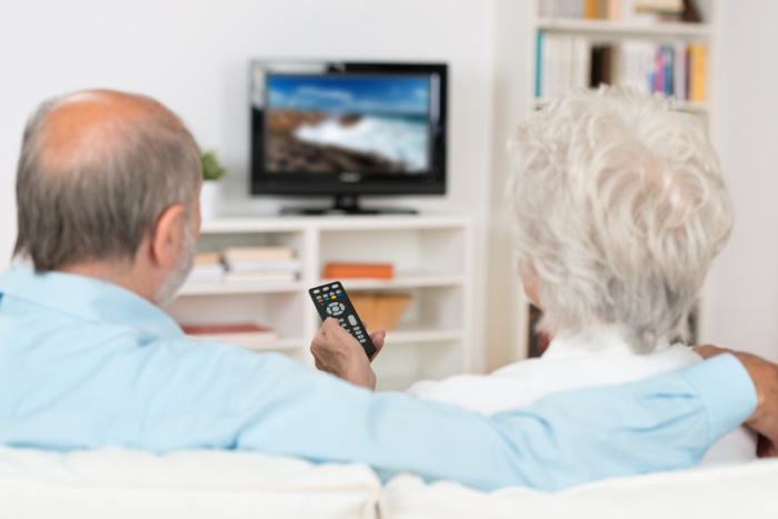 Elderly couple seniors watchingTV