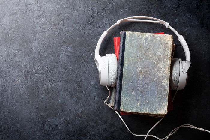 Audiobooks headphones and old book