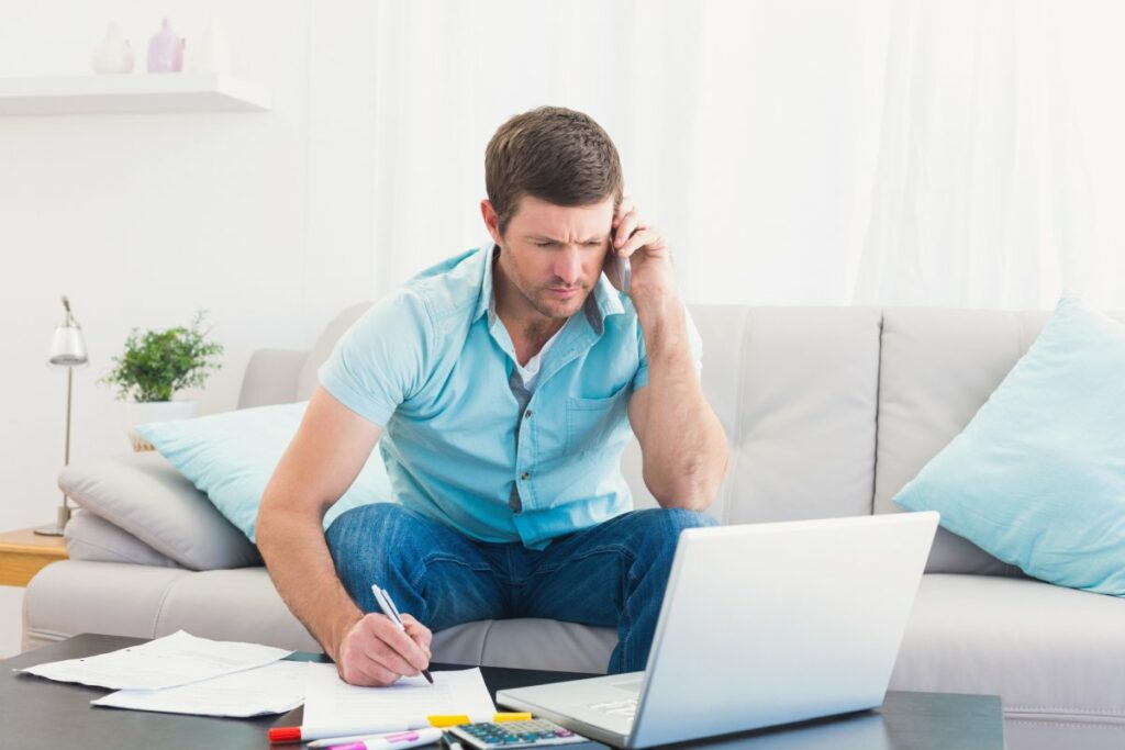 Man talking on phone haggling bills