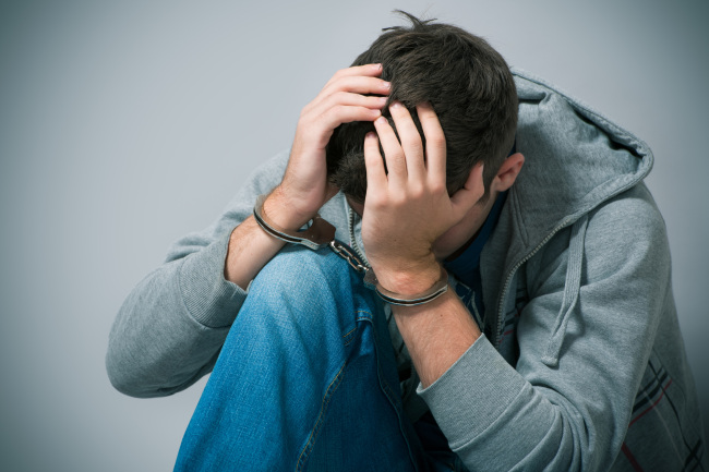 young man in handcuffs