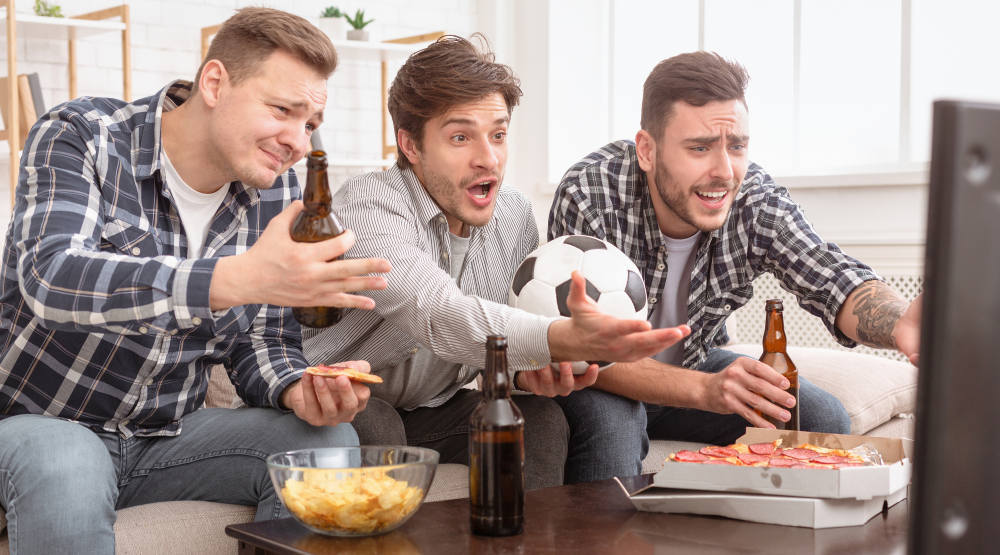 angry friends watching football on TV