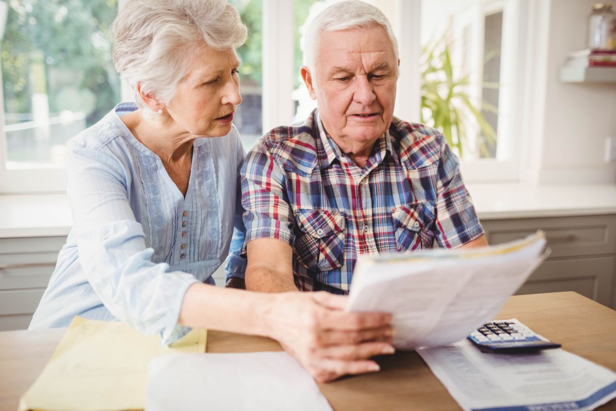 Senior couple checking bills