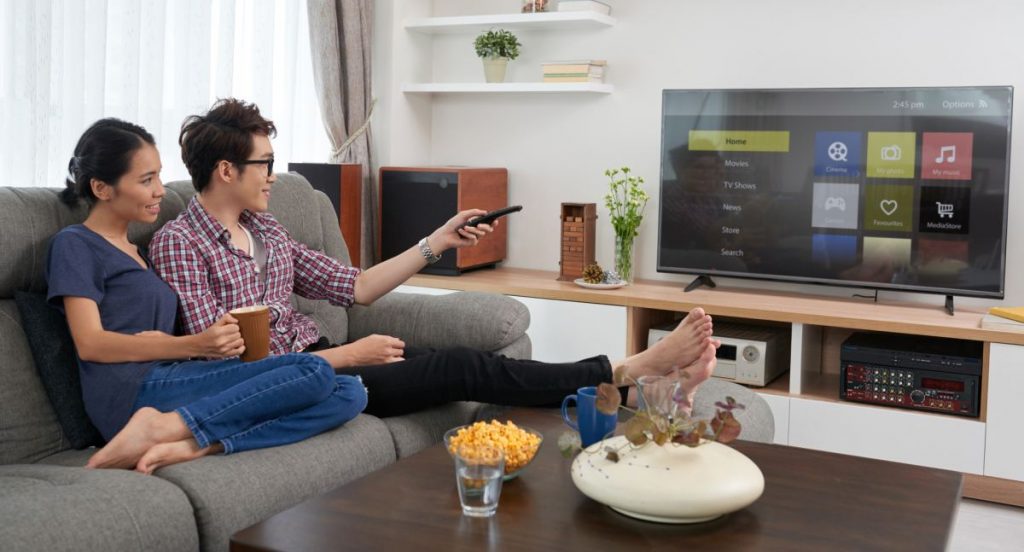 Couple watching smart TV in living room 1200