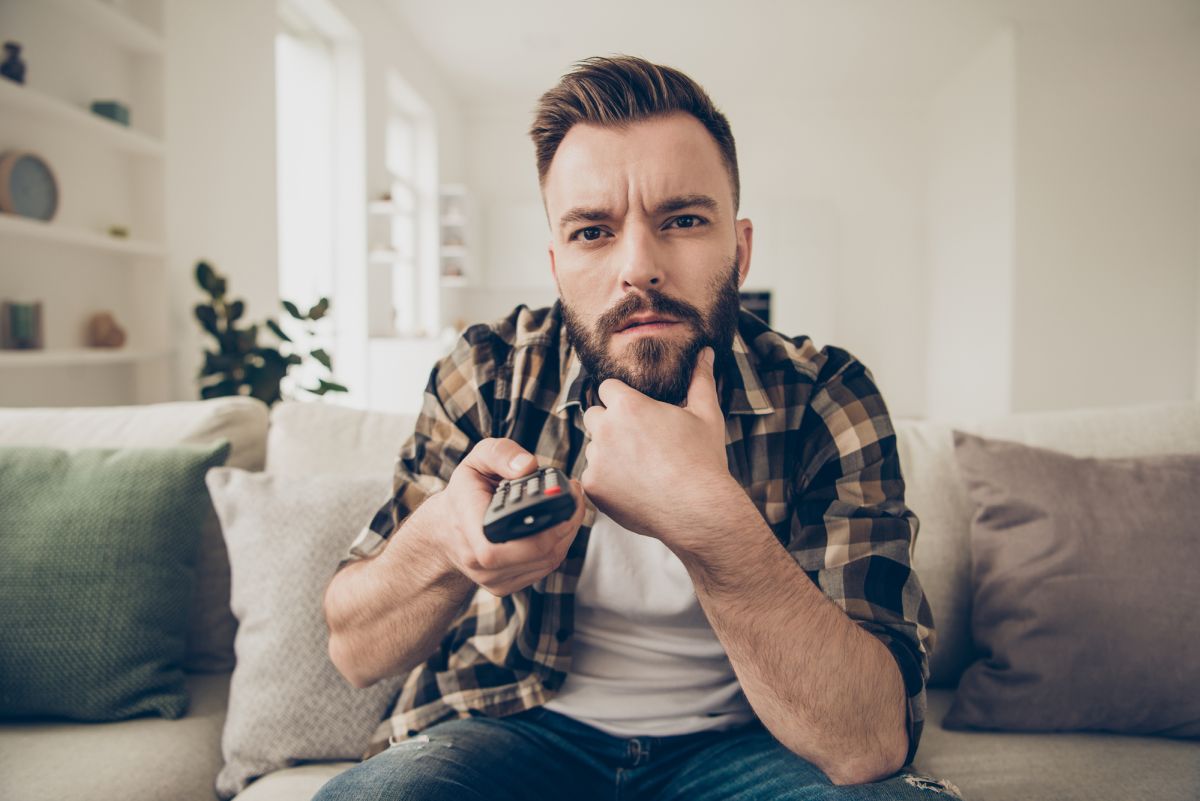 Man bearded with TV remote confused