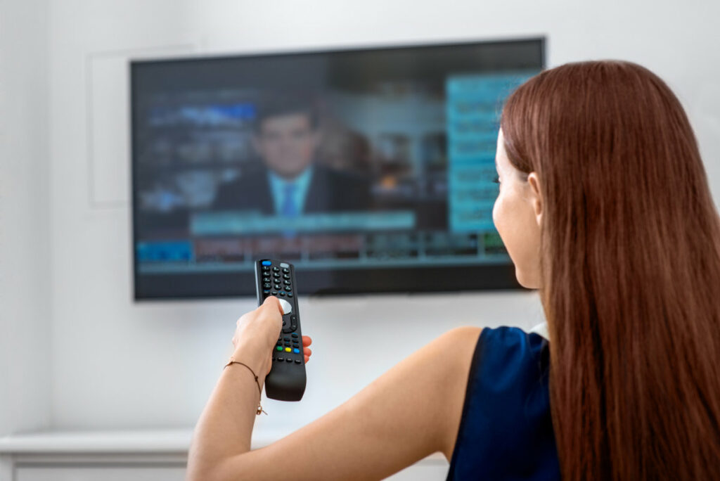 Woman watching TV remote