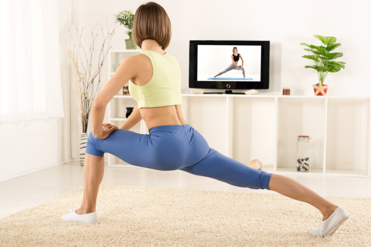 Woman exercising fitness in front of TV