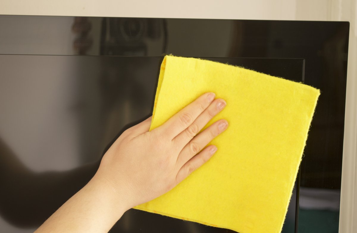 Hand cleaning a TV