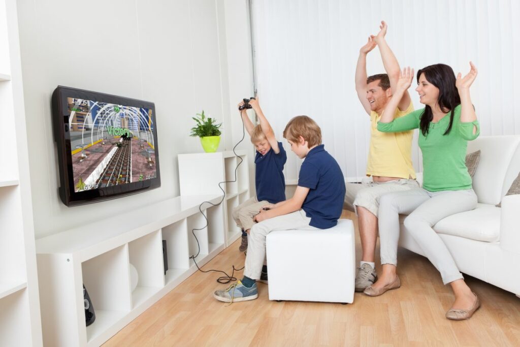 Family playing video games on TV