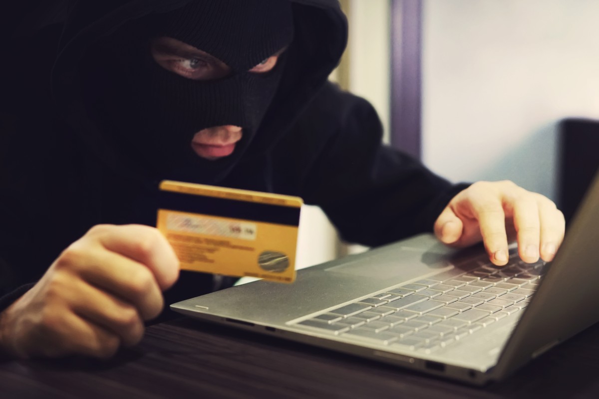 Hacker robber with credit card