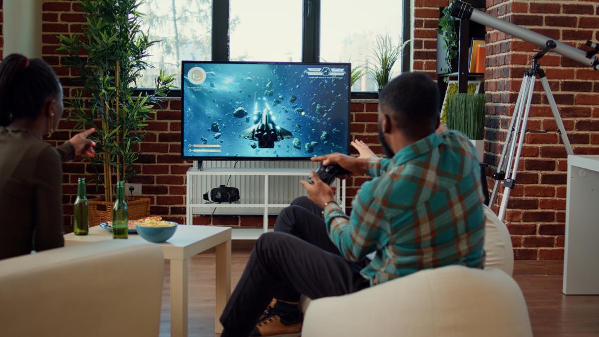 Video game console game on TV playing