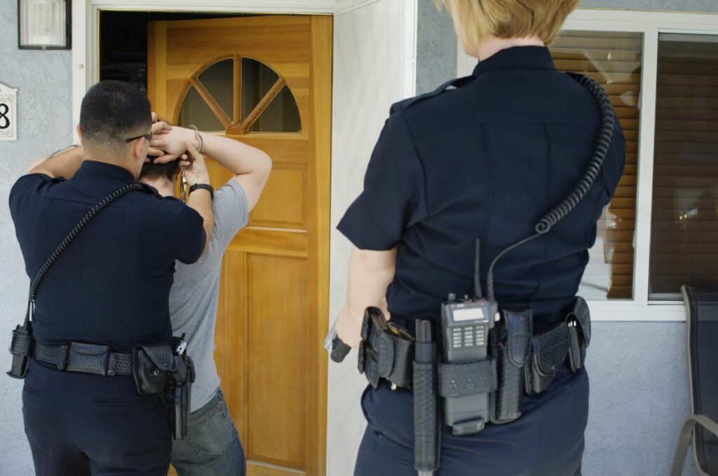 Police arresting man at the door