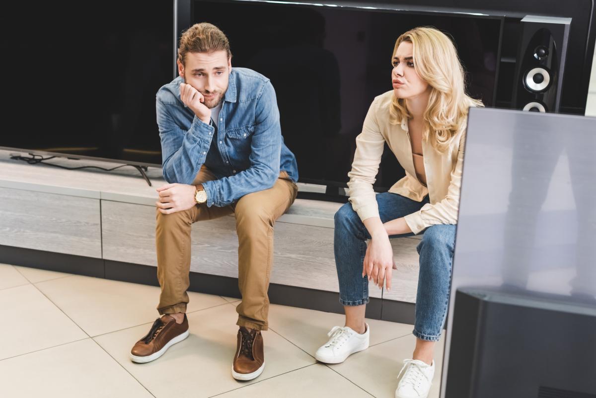 Sad couple in TV store
