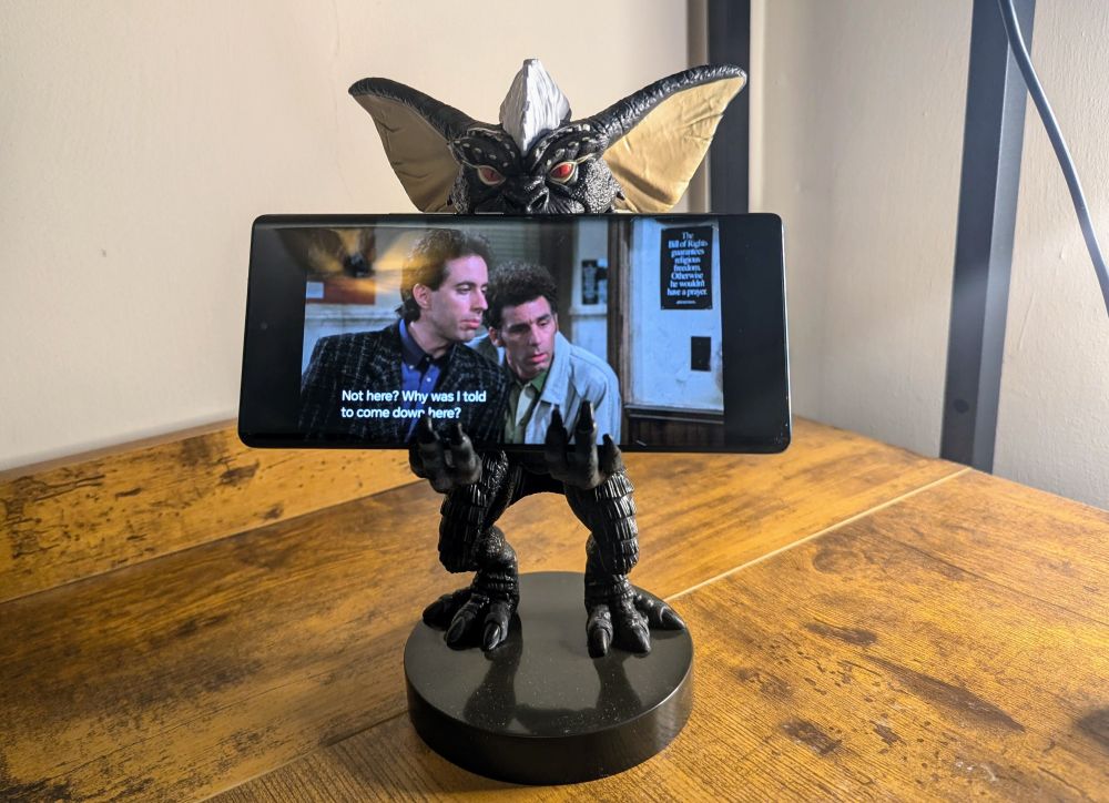 Gremlin holding phone
