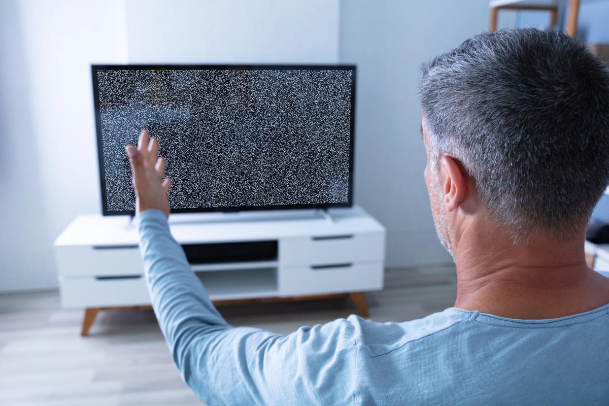 Man watching TV not working no signal broken